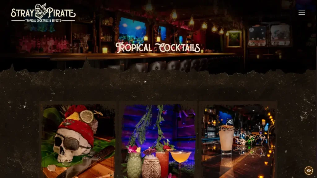 Stray Pirate tropical cocktails page showing its nautical bar interior, skull mug, and tiki drinks.